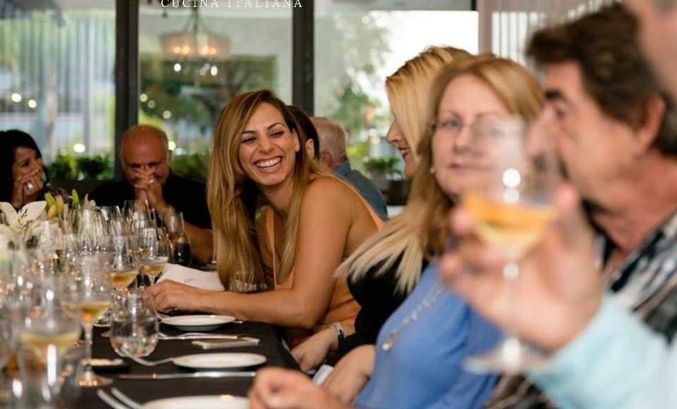 Guests laughing at corporate dinner at Vincenzo