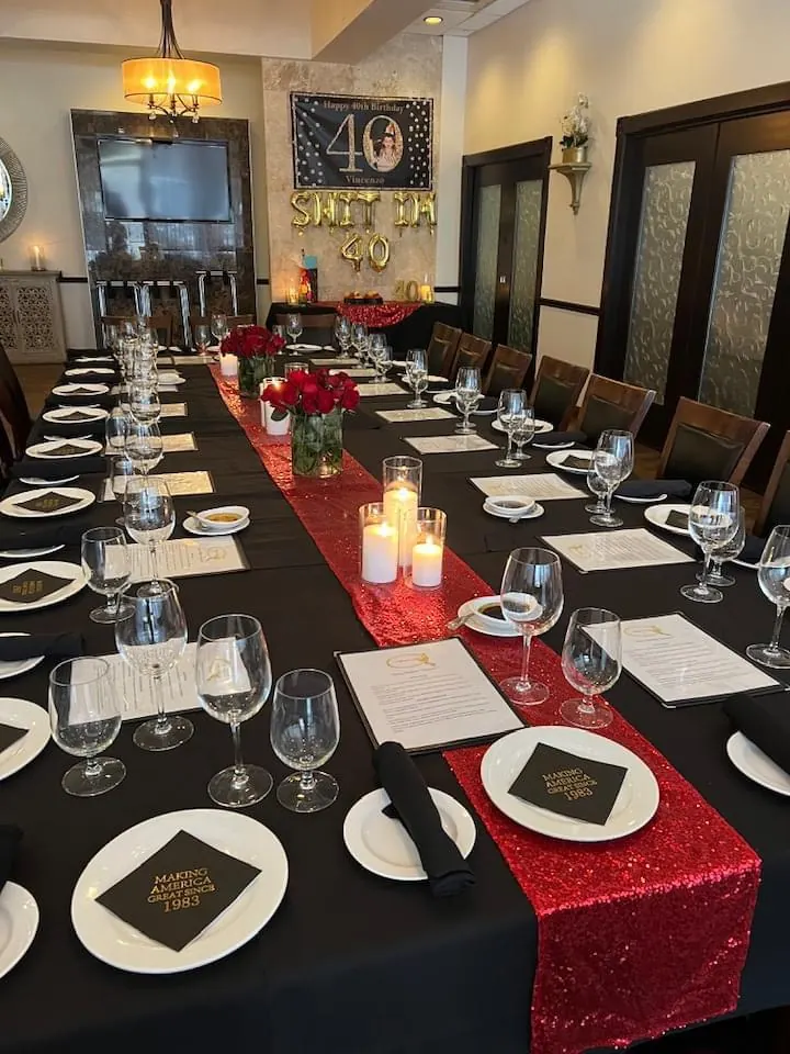 40th birthday table setup with red runner and candles at Vincenzo